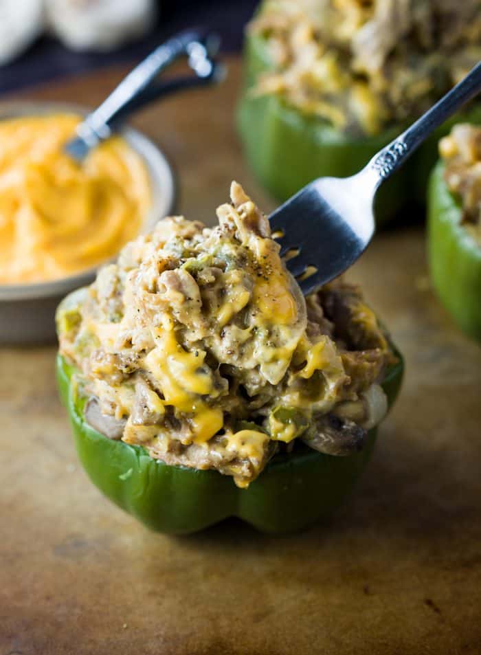 These Philly Cheesesteak Stuffed Peppers are loaded with onions, mushrooms, and thinly shaved steak smothered in warm cheese and tucked inside of a baked bell pepper. Stuffed Peppers