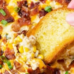 A labeled image of a piece of bread being dipped into cheesy corn dip.