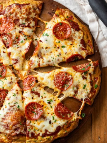 A Pepperoni Zucchini Crust Pizza on a pizza stone.