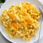 Baked Mac and Cheese on a white plate with a fork on the side.