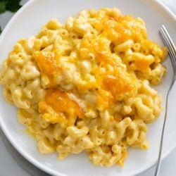 Baked Mac and Cheese on a white plate with a fork on the side.