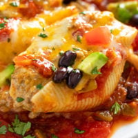 A Taco Stuffed Pepper filled with meat and topped with cheese and taco toppings.
