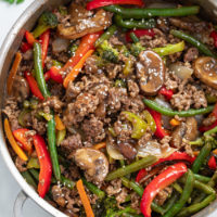 Ground Beef Stir Fry in a skillet with a brown sauce and vegetables.