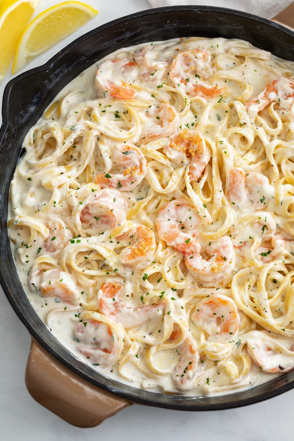 A skillet filled with Shrimp Alfredo with Fettucine.