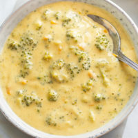 Broccoli Cheese Soup in a bowl with a spoon in it.