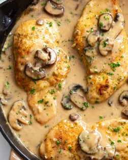 Chicken Marsala in a skillet with marsala wine sauce with mushrooms.