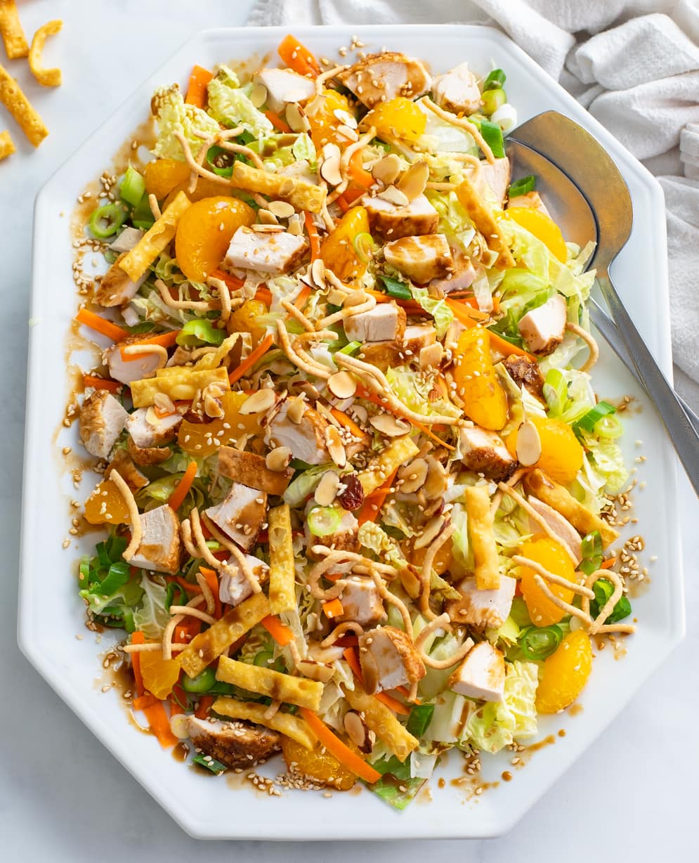 A white platter filled with Chinese Chicken Salad and homemade dressing.
