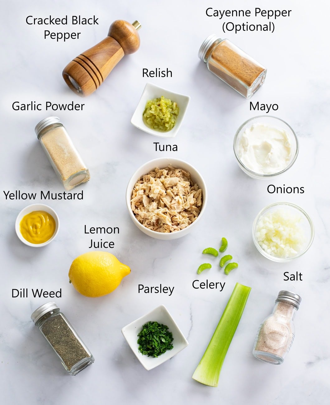 Ingredients for Tuna Salad on a white surface with labels.