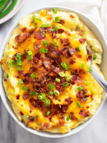 Overhead view of Loaded Mashed Potatoes with cheese, bacon, and green onions.
